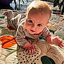 baby, chair, child, clothing, crawling, curious, cute, expression, eyes, face, floor, hands, home, indoors, infant, patterned_mat, plant, playmat, sunlight, window
