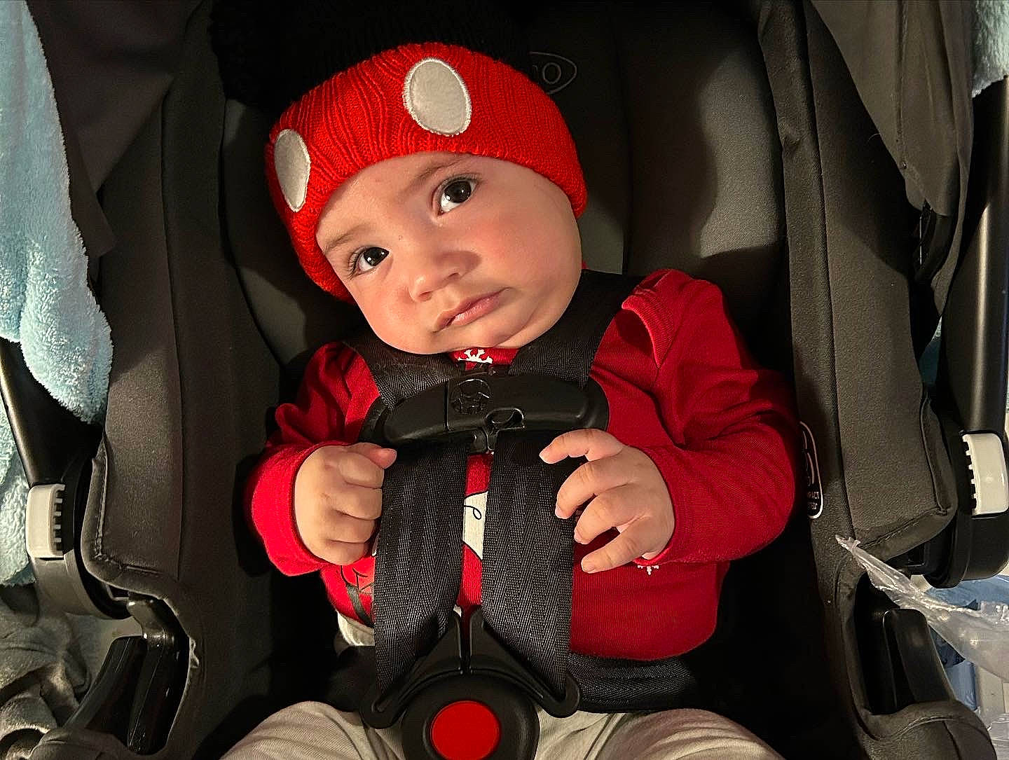 Adriel is registered to the contest to win money with this photo: auto_part, baby, baby_carriage, baby_products, baby_safety, baby_toddler_clothing, cap, car_seat, carmine, cheek, child, comfort, headwear, outerwear, person, personal_protective_equipment, product, red, seat_belt, sitting