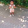casual_clothing, child, concrete, cute, daylight, drinking, greenery, juice_box, nature, outdoor, person, shadows, shoes, sidewalk, standing, summer, sunlight, toddler, trees, young_child