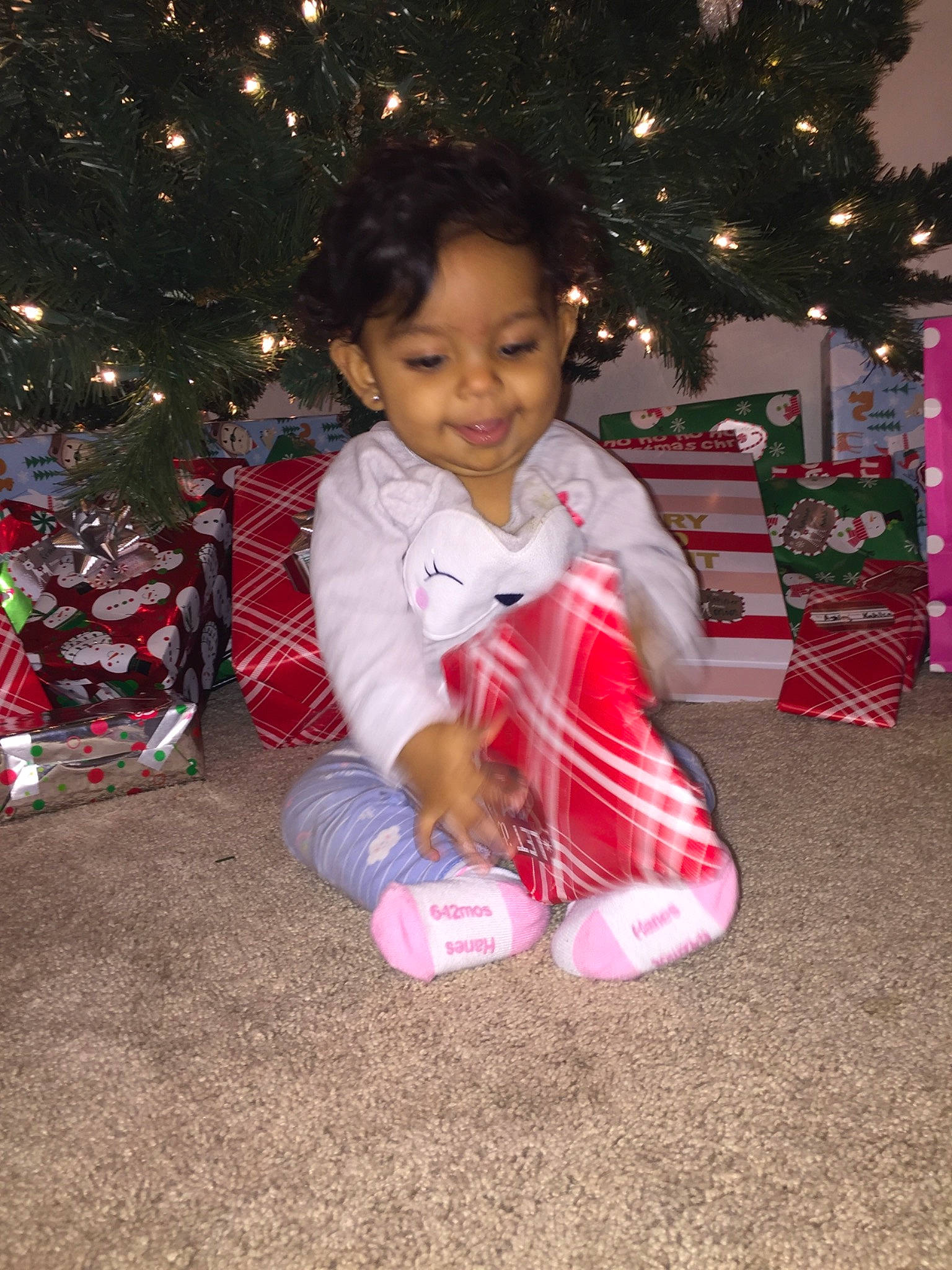 Zariah is registered to the contest to win money with this photo: child, christmas, christmas_decoration, christmas_eve, christmas_tree, event, happy, holiday, joy, person, pink, plant, play, smile, toddler, tree