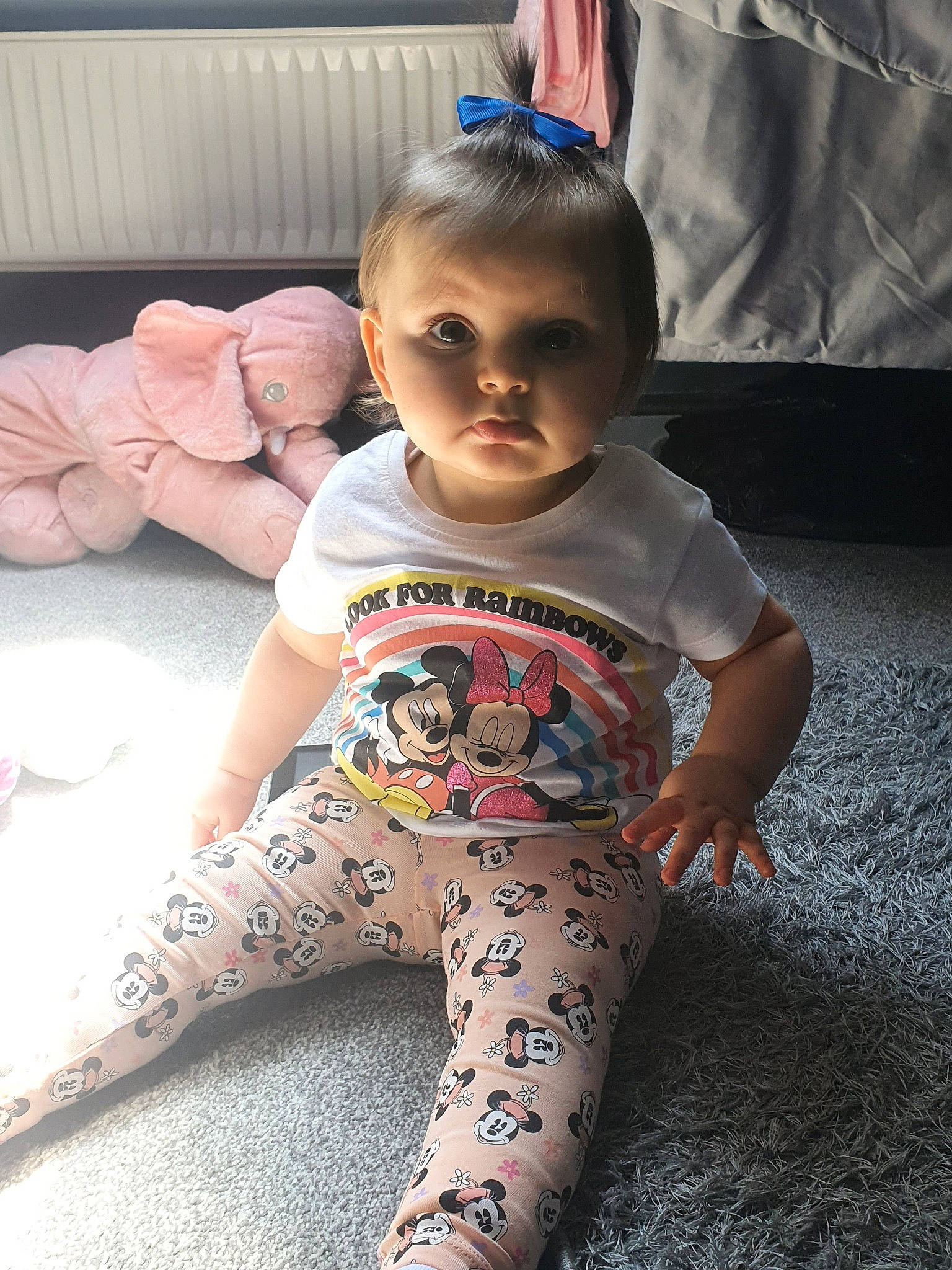 Skyla is registered to the contest to win money with this photo: baby, baby_toddler_clothing, barefoot, cheek, child, chin, face, floor, flooring, foot, happy, head, human_leg, knee, pattern, person, sitting, skin, sleeve, thigh