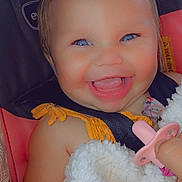 Hadley is registered to the contest to win money with this photo: baby, smiling, blue_eyes, blanket, pacifier, car_seat, bow, child, happy, cute, face, infant, clothing, hand, portrait, seatbelt, closeup, skin, baby_girl, expressive