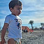 child, toddler, beach, diaper, t-shirt, spiderman, sky, sand, palm_tree, bracelet, portrait, side_profile, sunlight, outdoors, curious, expression, short_hair, bokeh, daytime, person