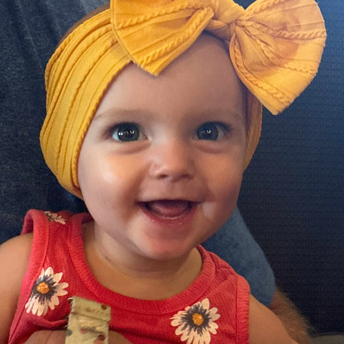 Aunicca joined the competition — help win amazing prizes! baby, bright_colors, child, closeup, cute, daisy_flowers, expressive_eyes, face, happy, headwear, headwrap, holding, indoor, infant, person, portrait, red_clothing, skin, smiling, yellow_bow