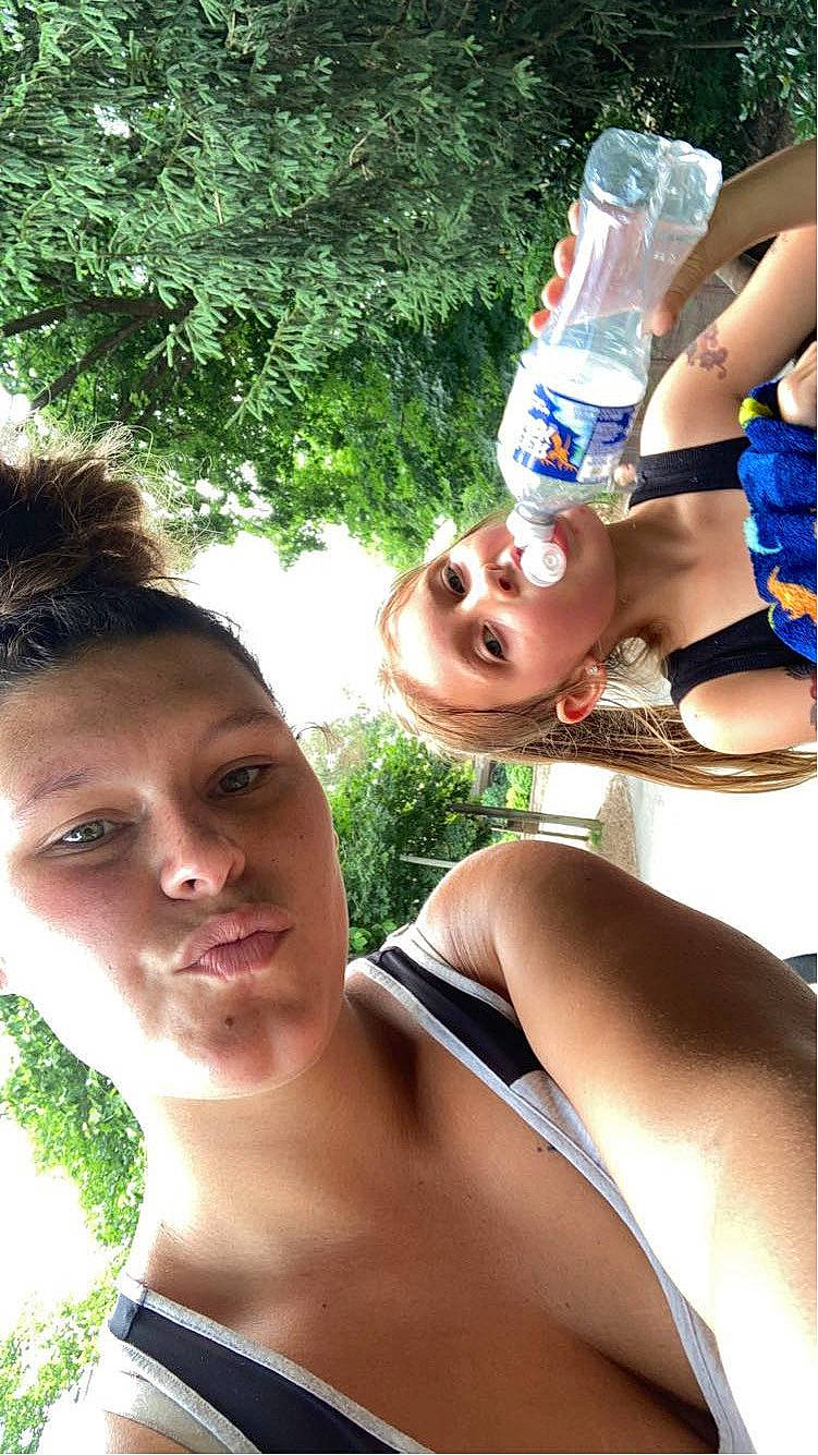 Lexi is registered to the contest to win money with this photo: brassiere, chest, eyewear, fun, grass, happy, human_leg, leisure, muscle, people_in_nature, person, plastic_bottle, recreation, selfie, summer, swimwear, thigh, tree, vacation, water