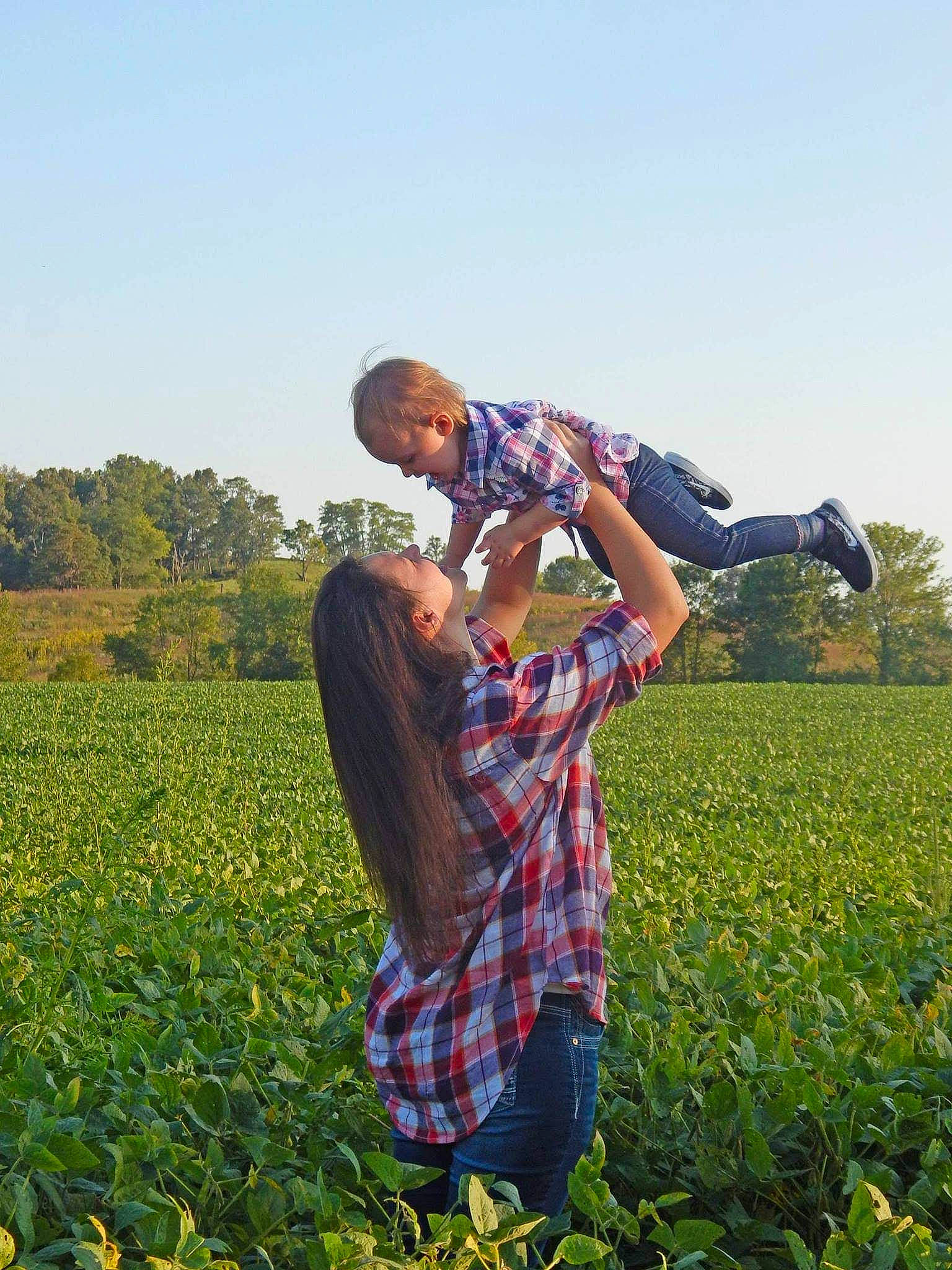 Lexi is registered to the contest to win money with this photo: agriculture, cash_crop, farmworker, field, flower, flowering_plant, gesture, grass, grassland, green, happy, landscape, natural_landscape, pasture, people_in_nature, person, plant, prairie, shirt, sky