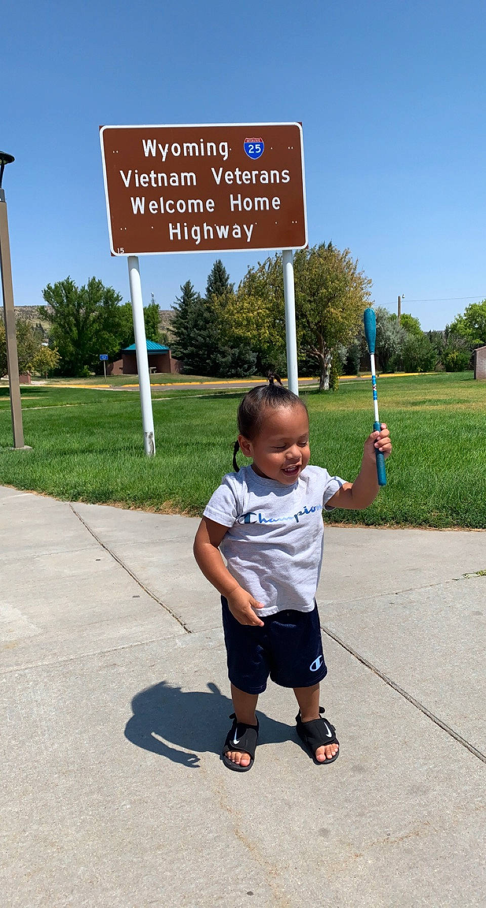 Kenneth joined the competition — help win amazing prizes! asphalt, city, fun, gesture, grass, leisure, person, plant, pole, public_space, recreation, road, road_surface, sandal, shorts, signage, sky, sleeve, t_shirt, toddler