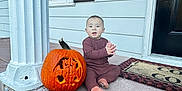 Antonio joined the competition — help win amazing prizes! baby, bat_design, brick_steps, carved_pumpkin, child, column, cozy_clothing, decor, door, doormat, fall, front_porch, holiday, outdoor, person, porch, pumpkin, sitting, smiling, window