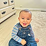 Antonio joined the competition — help win amazing prizes! toddler, child, smiling, denim_overalls, striped_shirt, indoor, carpet, sitting, happy, cute, face, person, floor, cabinet, drawer, window, light, clothing, shoe, room