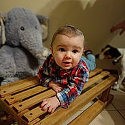 Charly a rejoint le concours — aidez-le/la à gagner de superbes lots ! animal, baby, casual_clothing, child, crawling, curious, dog, expression, floor_tiles, furniture, home, indoor, person, pet, plaid_shirt, playful, stuffed_elephant, toy, wooden_bench, young_child