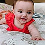 Nevaeh is registered to the contest to win money with this photo: baby, child, smiling, red_clothing, bed, elephant_pattern, hand, face, cute, infant, happy, indoors, portrait, lying_down, blanket, skin, young_child, eyes, mouth, expression