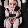 baby, infant, car_seat, headband, pink_clothing, mittens, child, seatbelt, cute, portrait, indoor, safety_harness, young_child, person, apparel, expression, face, looking_at_camera, closeup, newborn