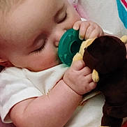 Nevaeh joined the competition — help win amazing prizes! baby, sleeping, pacifier, plush_toy, blanket, infant, closeup, child, cute, hand, soft_toy, peaceful, rest, cozy, indoors, white_clothing, pink, yellow, face, relaxation