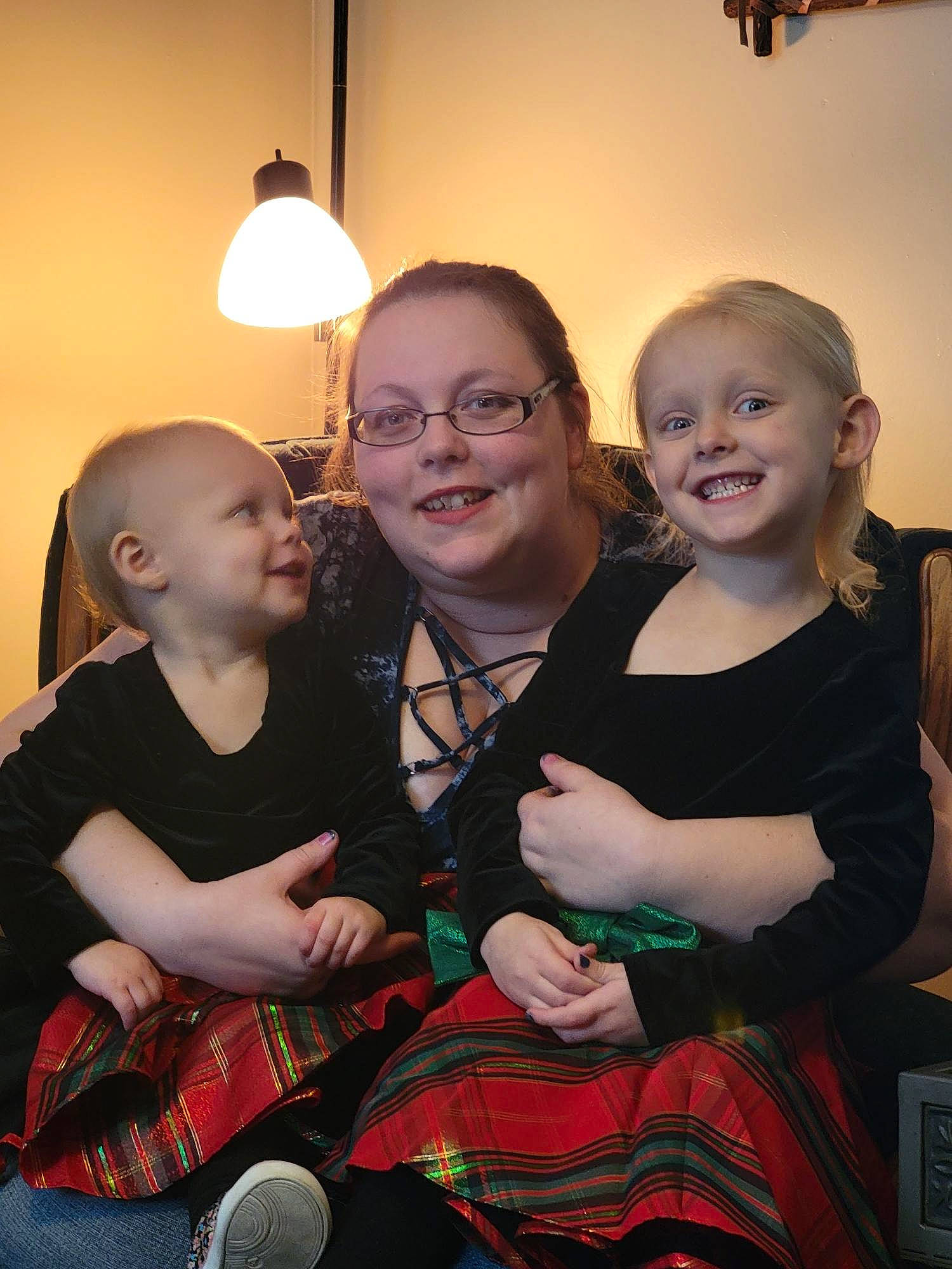 Charlilynn is registered to the contest to win money with this photo: baby_toddler_clothing, black, child, dress, event, face, flash_photography, formal_wear, fun, glasses, happy, human, joy, lighting, pattern, person, plaid, skin, smile, sock