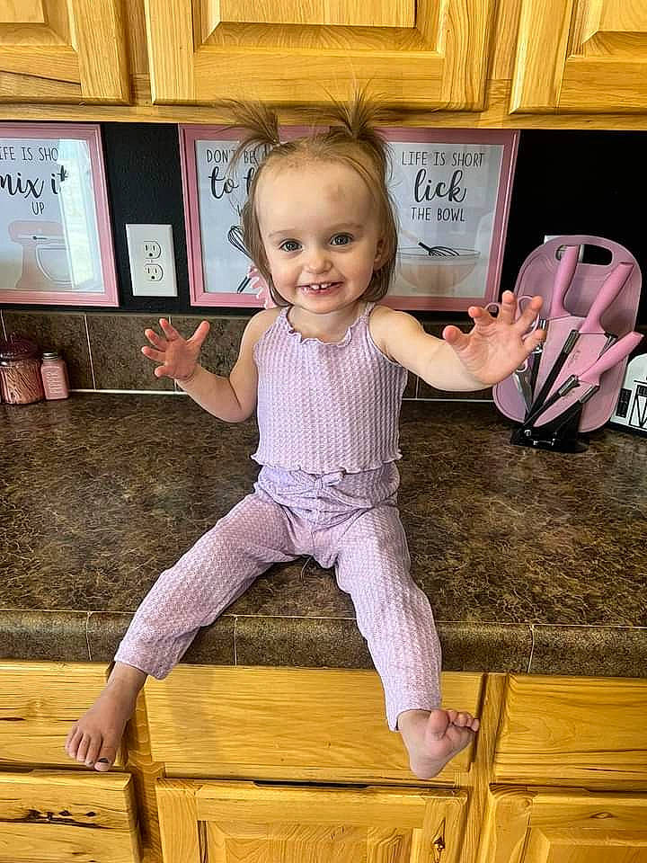 Akeeva joined the competition — help win amazing prizes! baby_toddler_clothing, facial_expression, finger, floor, flooring, fun, gesture, happy, hardwood, joy, person, picture_frame, pink, sleeve, smile, standing, t_shirt, thigh, thumb, toddler