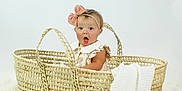 Bonnie joined the competition — help win amazing prizes! baby, infant, basket, bow, headband, surprised, expression, blanket, white, soft, fur, cute, child, portrait, sitting, indoors, clothing, pink, woven, adorable