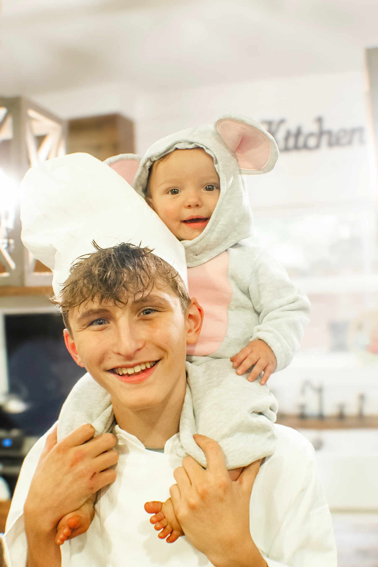 Bonnie is registered to the contest to win money with this photo: child, baby, costume, mouse_ears, chef_hat, smiling, portrait, indoor, kitchen, person, happy, young_boy, toddler, cute, family, holding, playful, head_and_shoulders, casual_clothing, home