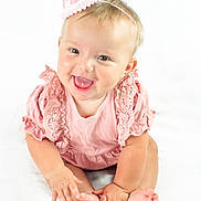 Bonnie joined the competition — help win amazing prizes! baby, child, smiling, pink_clothing, party_hat, sitting, cute, happy, portrait, infant, hands, feet, skin, studio, white_background, frilly, celebration, headband, expression, joy