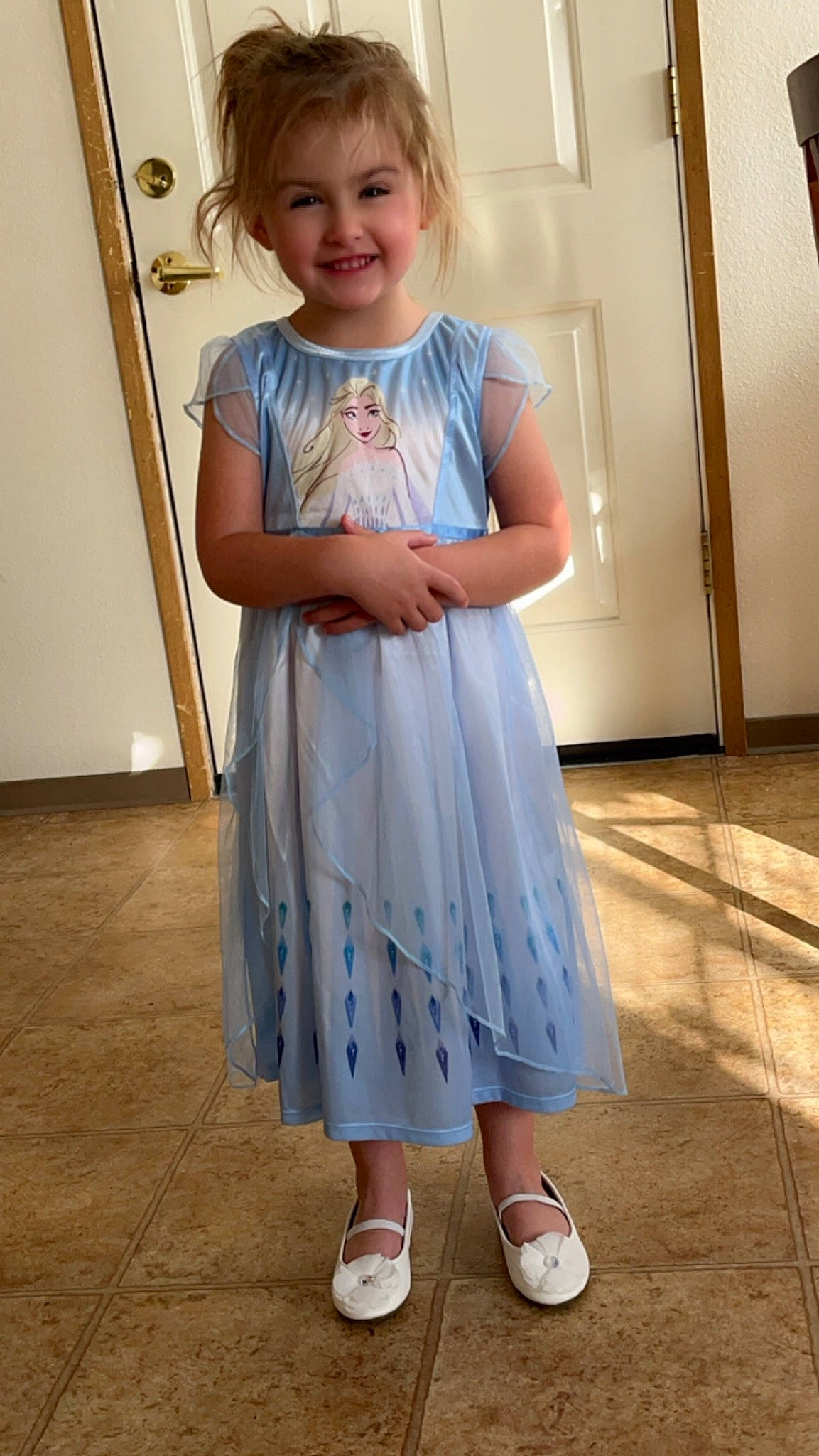 Amber is registered to the contest to win money with this photo: baby_toddler_clothing, child, day_dress, dress, electric_blue, flooring, formal_wear, human_leg, joint, joy, neck, one_piece_garment, pattern, person, shoulder, sleeve, smile, standing, toddler, waist