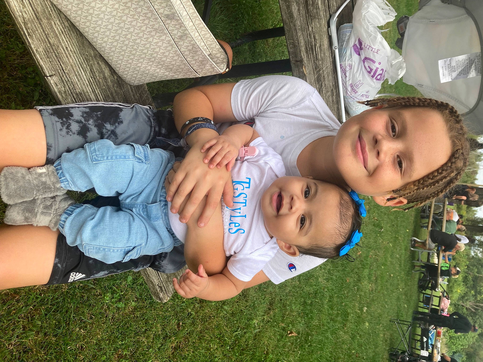 Jaylee is registered to the contest to win money with this photo: child, comfort, event, facial_expression, fun, grass, happy, human_leg, joy, lap, leaf, leisure, person, plant, recreation, sitting, smile, thigh, toddler, tree