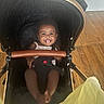 Maleah is registered to the contest to win money with this photo: baby, baby_girl, black_stroller, child, clothing, cute, expression, face, happy, head, indoor, infant, person, playful, seatbelt, seated, smile, stroller, tongue_out, wooden_floor