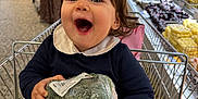 Charlotte joined the competition — help win amazing prizes! toddler, child, shopping_cart, broccoli, grocery_store, produce, happy, smiling, food, plastic_wrap, aisle, person, indoor, clothing, curly_hair, shopping, supermarket, baby, holding, retail