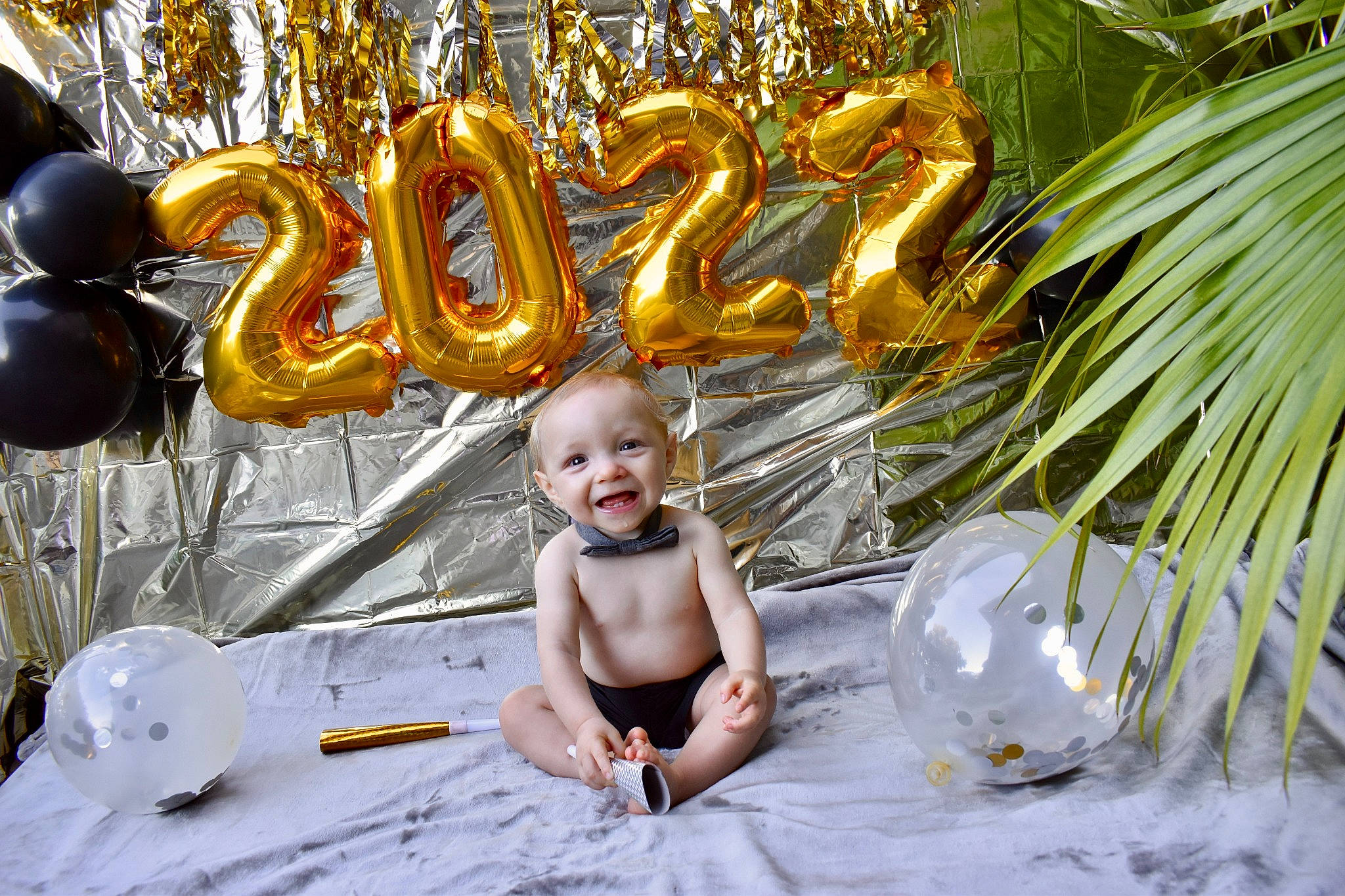 Bryce is registered to the contest to win money with this photo: arecales, baby, baby_toddler_clothing, brass_instrument, christmas_decoration, christmas_ornament, event, evergreen, fun, grass, happy, holiday, leisure, musical_instrument, palm_tree, person, plant, smile, terrestrial_plant, toddler