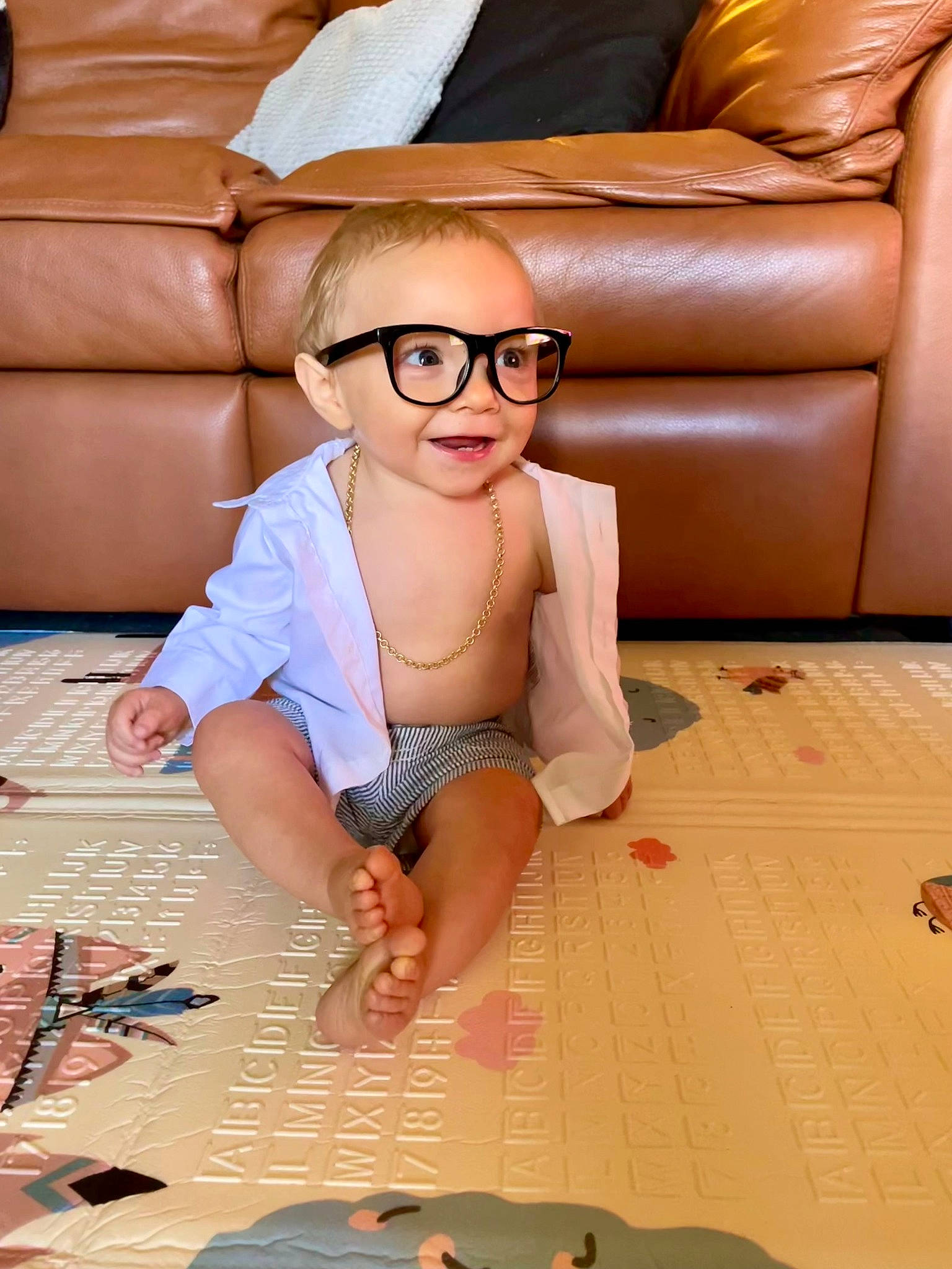 Bryce is registered to the contest to win money with this photo: comfort, couch, eyewear, finger, floor, flooring, glasses, hairstyle, happy, joint, leg, leisure, living_room, mouth, person, studio_couch, textile, thigh, vision_care, white