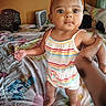 Genesis joined the competition — help win amazing prizes! baby, child, infant, person, bed, blanket, hand, headband, orange_bow, striped_clothing, indoors, curious, standing, holding_hand, colorful, cartoon_characters, cute, room, window, soft_light