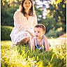 Itai is registered to the contest to win money with this photo: baby, woman, grass, outdoor, nature, sunlight, tree, greenery, child, crawling, dress, portrait, adult, daylight, lace, happy, people, photography, blurred_background, warm_light