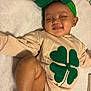 Kulture joined the competition — help win amazing prizes! baby, child, smiling, headband, bow, green, four_leaf_clover, cereal, cereal_box, lying_down, soft_surface, clothing, infant, cute, happy, indoors, food, snack, toddler, peaceful