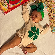 Kulture is registered to the contest to win money with this photo: baby, sleeping, cereal, lucky_charms, marshmallows, rainbow, blanket, green_headband, four_leaf_clover, infant, food, spilled_cereal, cute, soft_texture, lying_down, clothing, headwear, colorful, relaxing, indoor