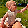 baby, child, outdoor, bubbles, grass, sunlight, blue_sky, person, sleeveless_shirt, curious, playing, summer, nature, skin, arm, lap, daylight, greenery, happy, portrait