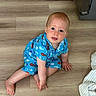 toddler, child, baby, floor, wooden_floor, blue_clothing, fish_pattern, sitting, indoors, blanket, curious, cute, portrait, crawling, infant, person, skin, hand, foot, head