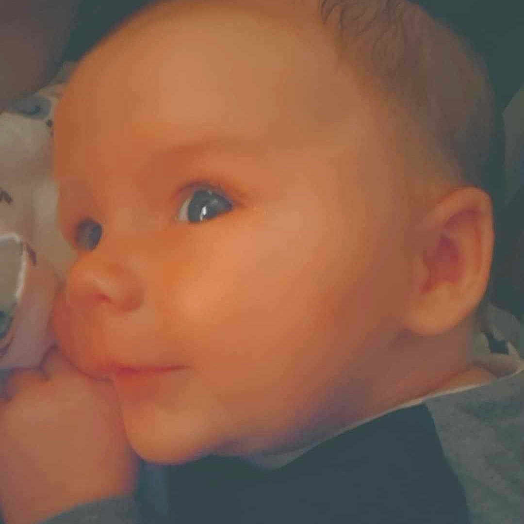 Waylon is registered to the contest to win money with this photo: baby, blue_eyes, child, close_up, clothing, cozy, cute, ear, expression, face, head, indoor, infant, person, portrait, skin, soft_light, tender, warm, young