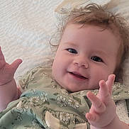 Blakeleigh is registered to the contest to win money with this photo: baby, baby_girl, child, closeup, clothing, curly_hair, cute, face, floral_dress, hand, happy, indoors, infant, lying_down, person, portrait, skin, smile, white_background, young