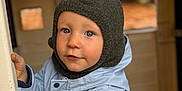 Stanislas a rejoint le concours — aidez-le/la à gagner de superbes lots ! toddler, child, blue_eyes, knit_hat, winter_jacket, outdoor, curious, cold_weather_clothing, portrait, face, person, cute, warm_clothing, baby, hand, looking, young_child, expression, playful, closeup