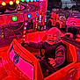Stanislas participe au concours pour gagner de l'argent avec cette photo : child, toddler, smiling, carnival, ride, toy_car, lights, colorful, amusement_park, happy, outdoor, fun, clothing, jacket, seat, playful, excited, face, vehicle, evening