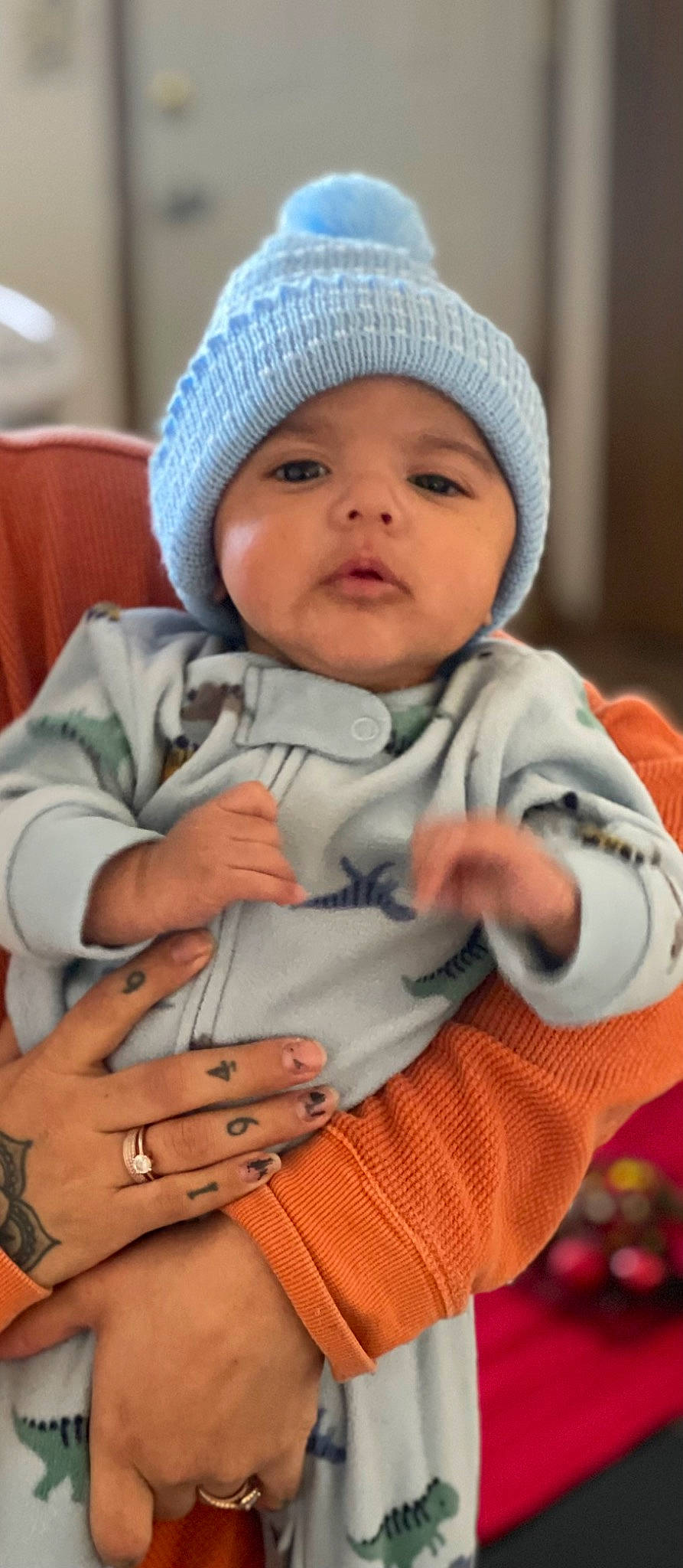 Ezra Mozes joined the competition — help win amazing prizes! baby, baby_toddler_clothing, cap, cheek, child, comfort, eye, finger, gesture, headwear, jewellery, knit_cap, nail, pattern, person, sitting, skin, sleeve, thumb, toddler