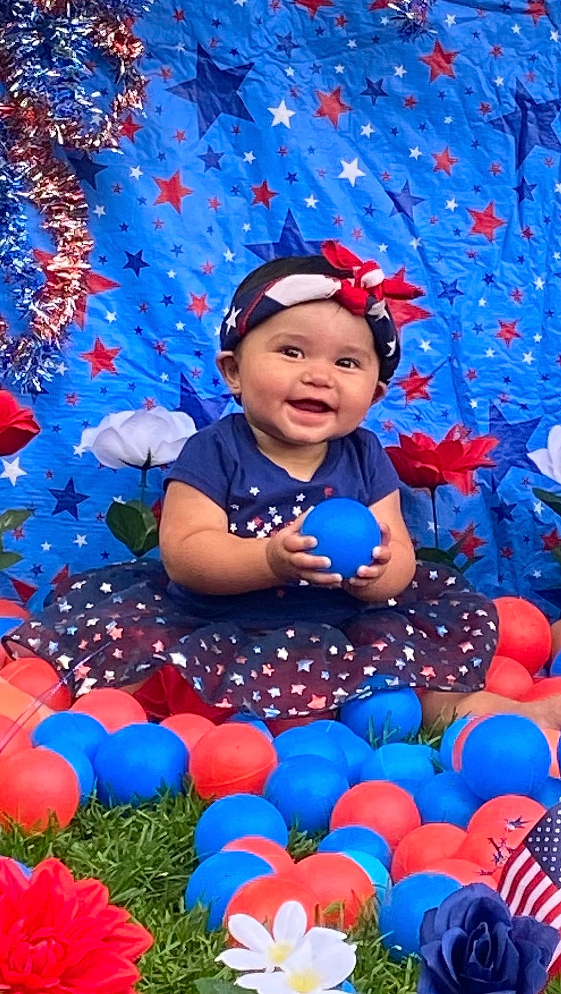 Kapri Mozes joined the competition — help win amazing prizes! azure, baby, baby_toddler_clothing, blue, child, electric_blue, face, facial_expression, fun, happy, headwear, light, nature, people, people_in_nature, person, petal, photograph, plant, red