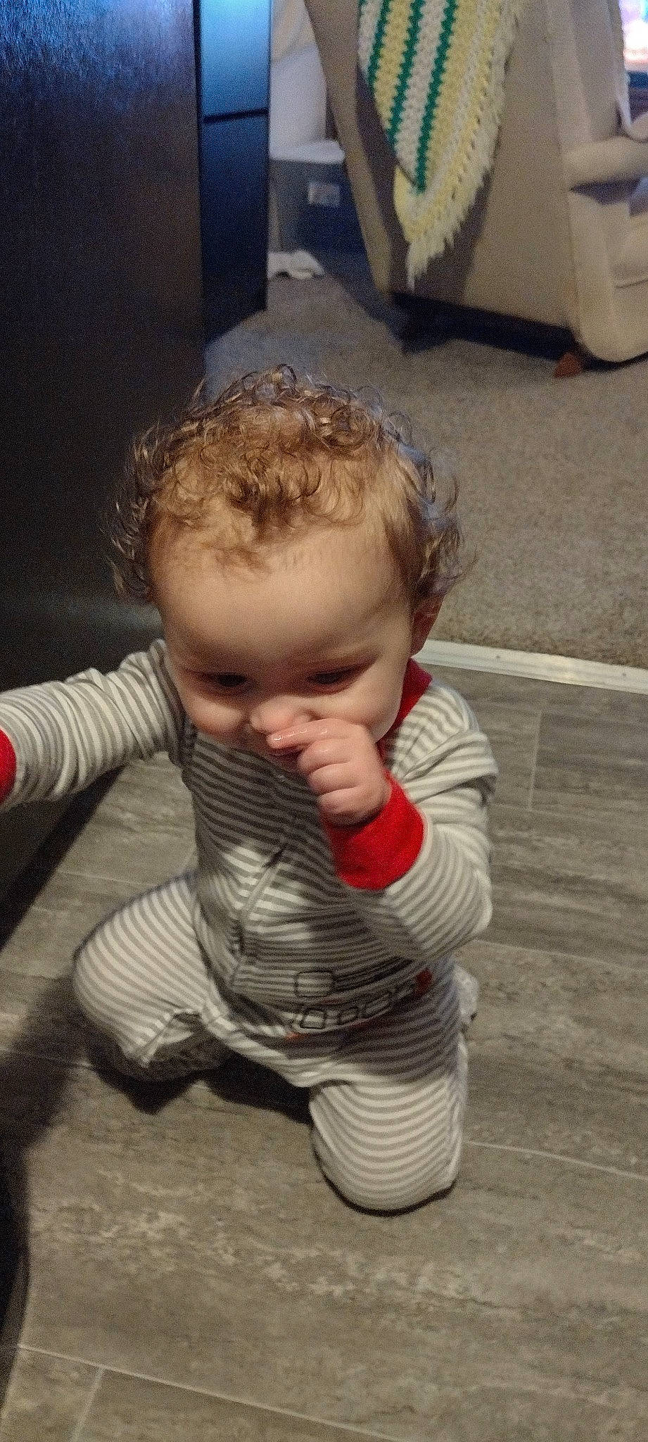 Dj is registered to the contest to win money with this photo: baby, baby_toddler_clothing, cheek, child, comfort, eye, face, facial_expression, floor, flooring, fun, hardwood, head, nose, person, sitting, skin, sleeve, thumb, toddler