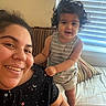 child, toddler, adult, selfie, portrait, smiling, happy, curly_hair, standing, indoor, home, couch, bed, cushion, window, blinds, striped_clothing, star_pattern, family, photography