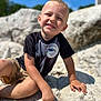 Asher James K Sabat is registered to the contest to win money with this photo: beachwear, blonde, bodypart, boy, child, clothing, face, hair, happy, head, male, person, photography, portrait, rock, shorts, sitting, sleeve, smile, t_shirt