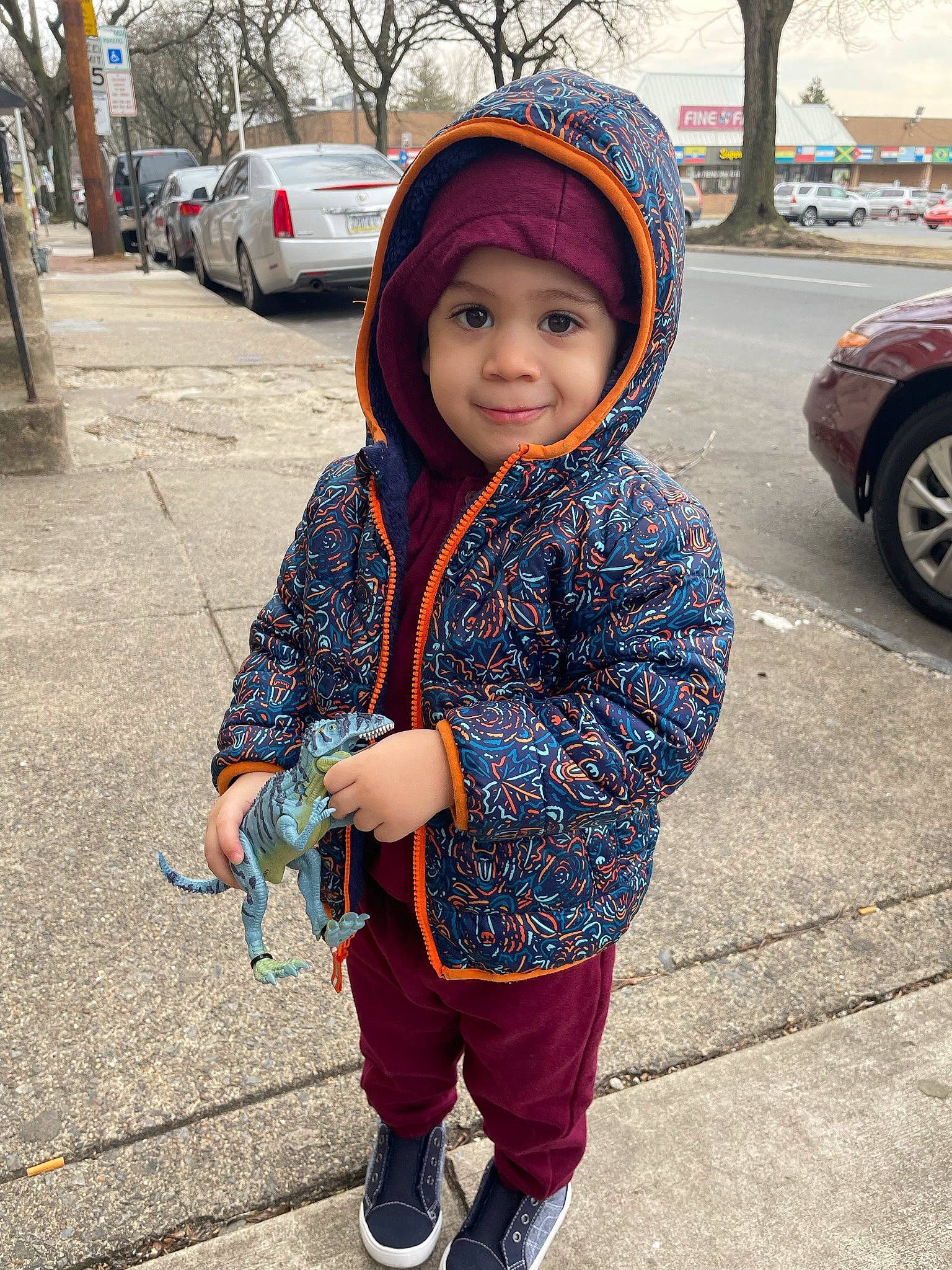 Adonis is registered to the contest to win money with this photo: asphalt, baby, car, cool, electric_blue, happy, headwear, jacket, joy, pattern, person, recreation, road, shoe, sidewalk, sleeve, smile, street_fashion, tire, toddler