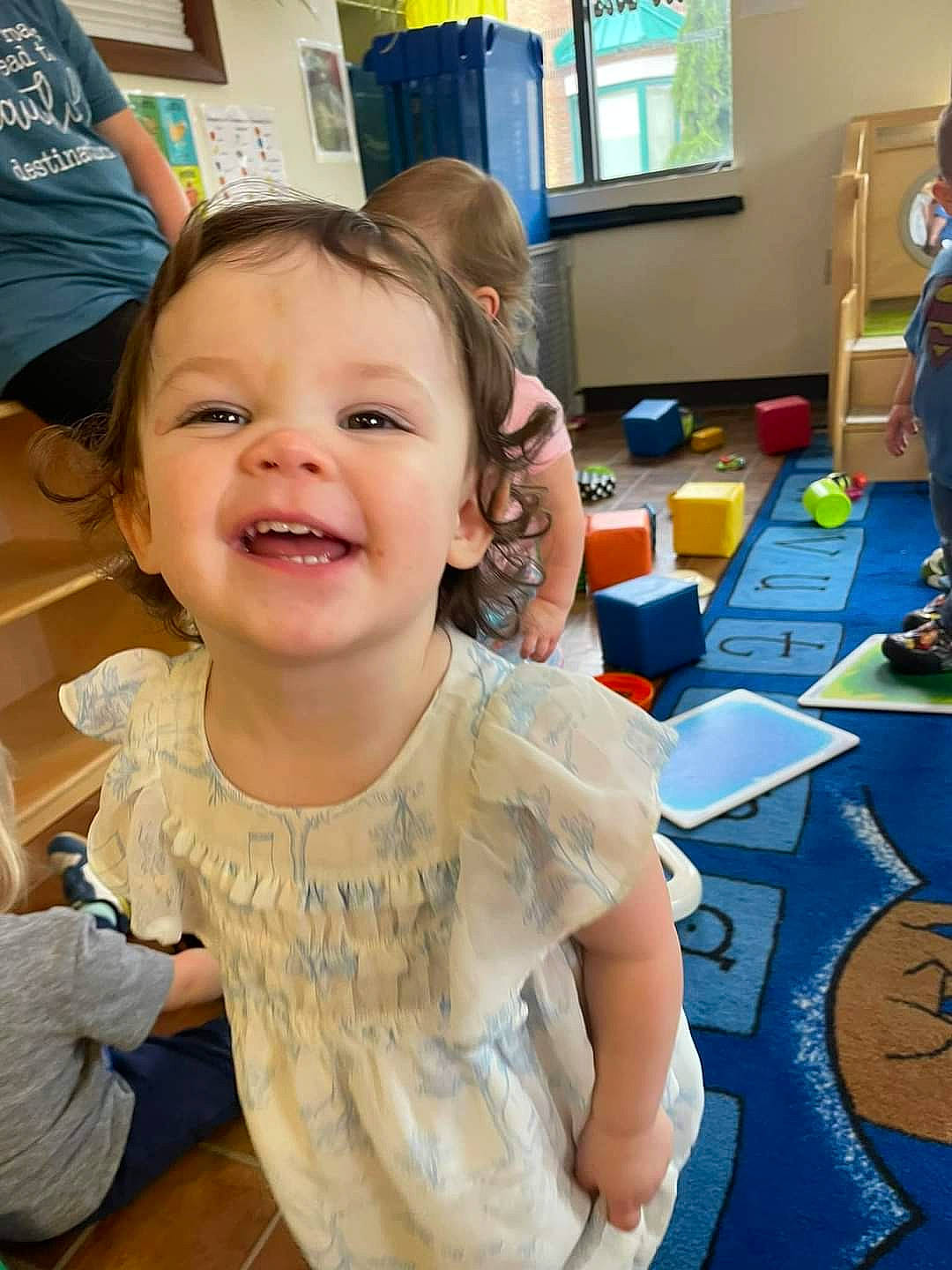 Amaryllis is registered to the contest to win money with this photo: chair, child, event, finger, flooring, fun, happy, joy, kindergarten, laugh, leisure, person, recreation, room, sitting, smile, summer, t_shirt, television, thumb