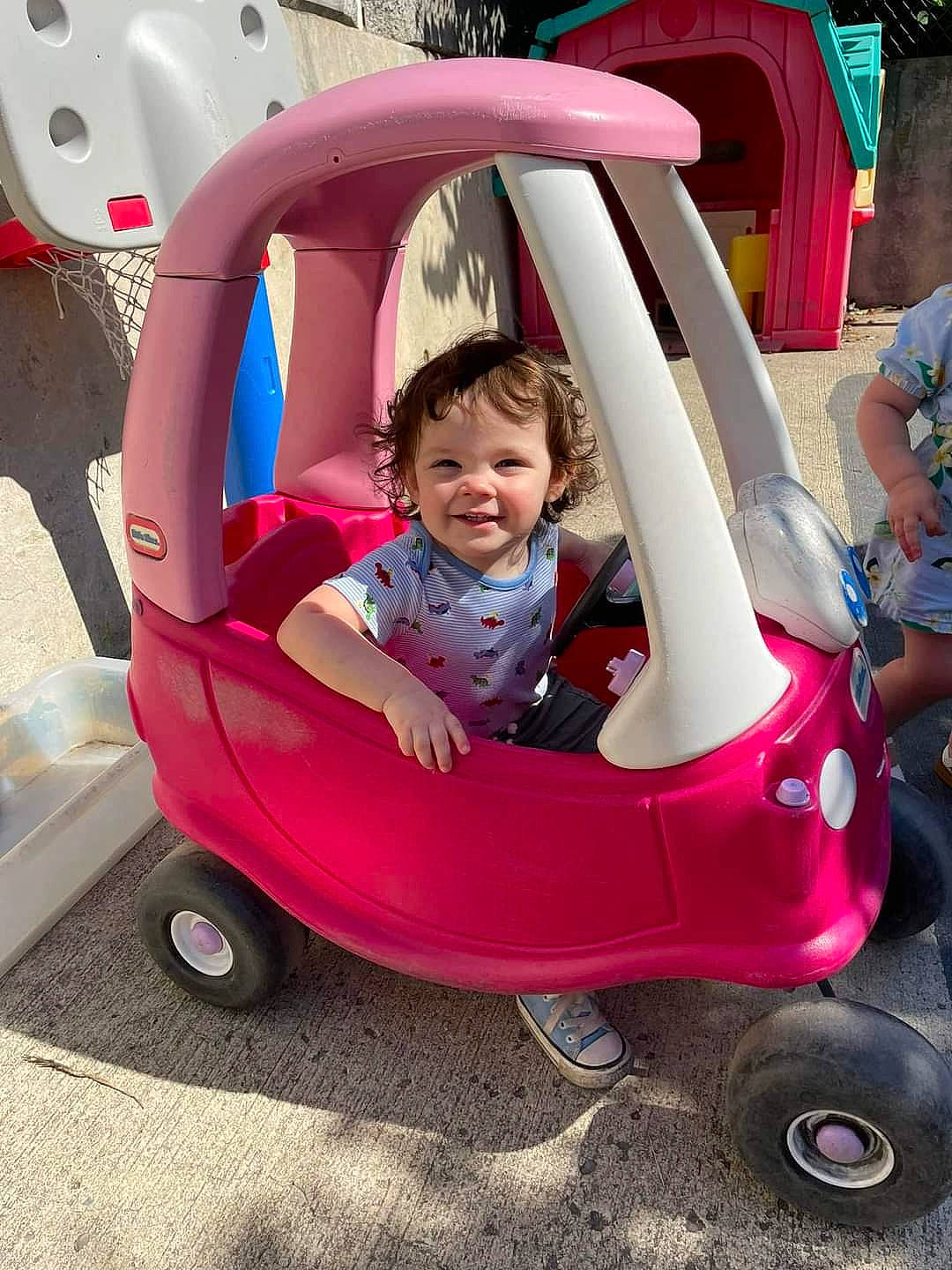 Amaryllis is registered to the contest to win money with this photo: auto_part, automotive_exterior, automotive_wheel_system, baby_carriage, baby_toddler_clothing, comfort, fender, fun, joy, leisure, magenta, mode_of_transport, motor_vehicle, person, pink, plant, shorts, smile, tire, toddler