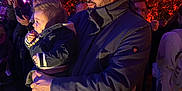 Anastasia participe au concours pour gagner de l'argent avec cette photo : man, child, toddler, baby, jacket, coat, socks, indoor, event, crowd, people, lighting, purple_light, red_light, plant, glasses, beard, holding, curious, face