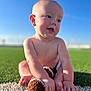 baby, child, infant, grass, outdoor, blue_sky, toy, football, knitted_toy, happy, smiling, sitting, sunlight, skin, bare_chest, cute, playful, daytime, nature, field