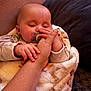 baby, sleeping, hand, blanket, pacifier, infant, cozy, couch, soft_texture, fingers, close_up, person, warm, comfort, rest, skin, relaxation, indoor, family, bond