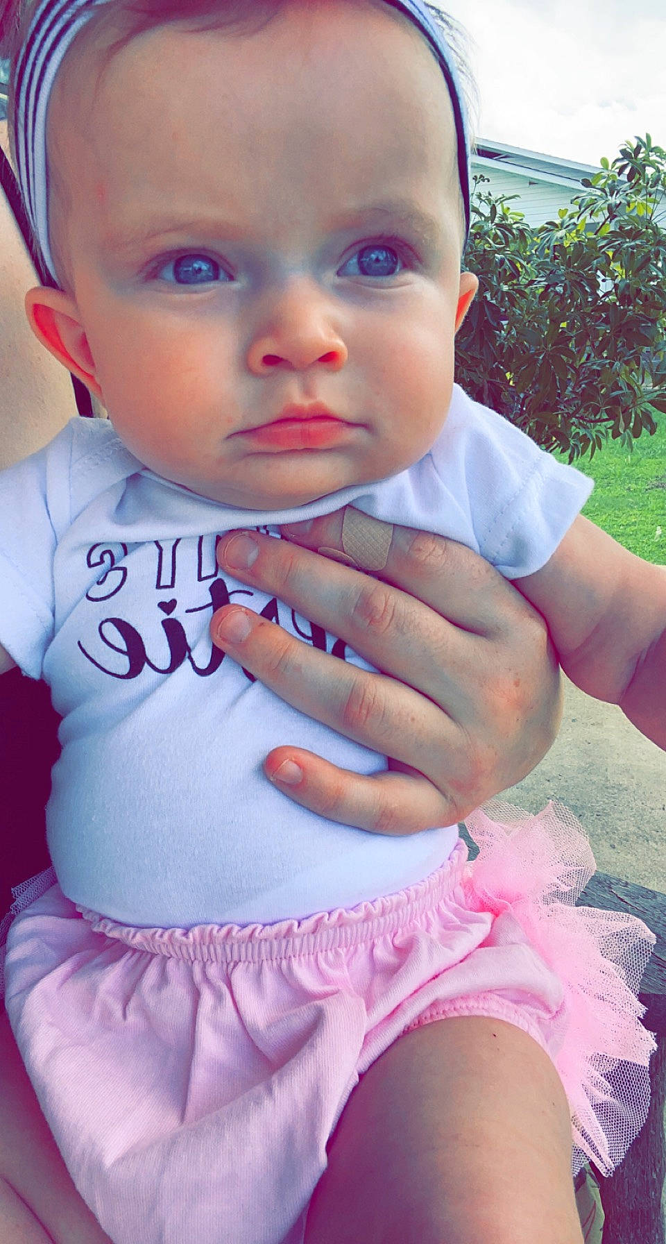 Timber is registered to the contest to win money with this photo: arm, baby_toddler_clothing, blue, eyelash, face, facial_expression, finger, gesture, hand, happy, head, iris, lip, muscle, neck, person, pink, plant, skin, sleeve